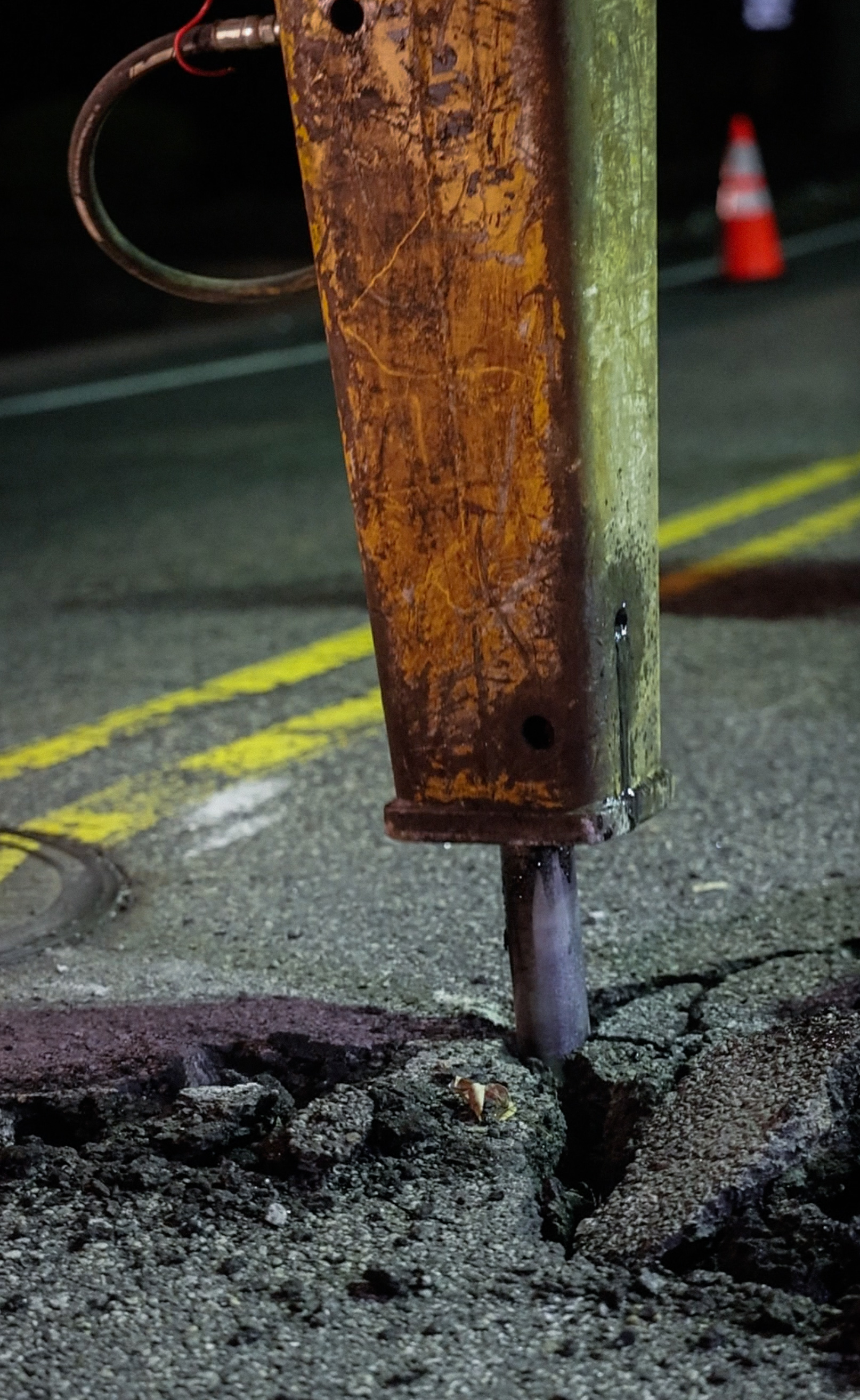 Hydraulic hammer breaking pavement