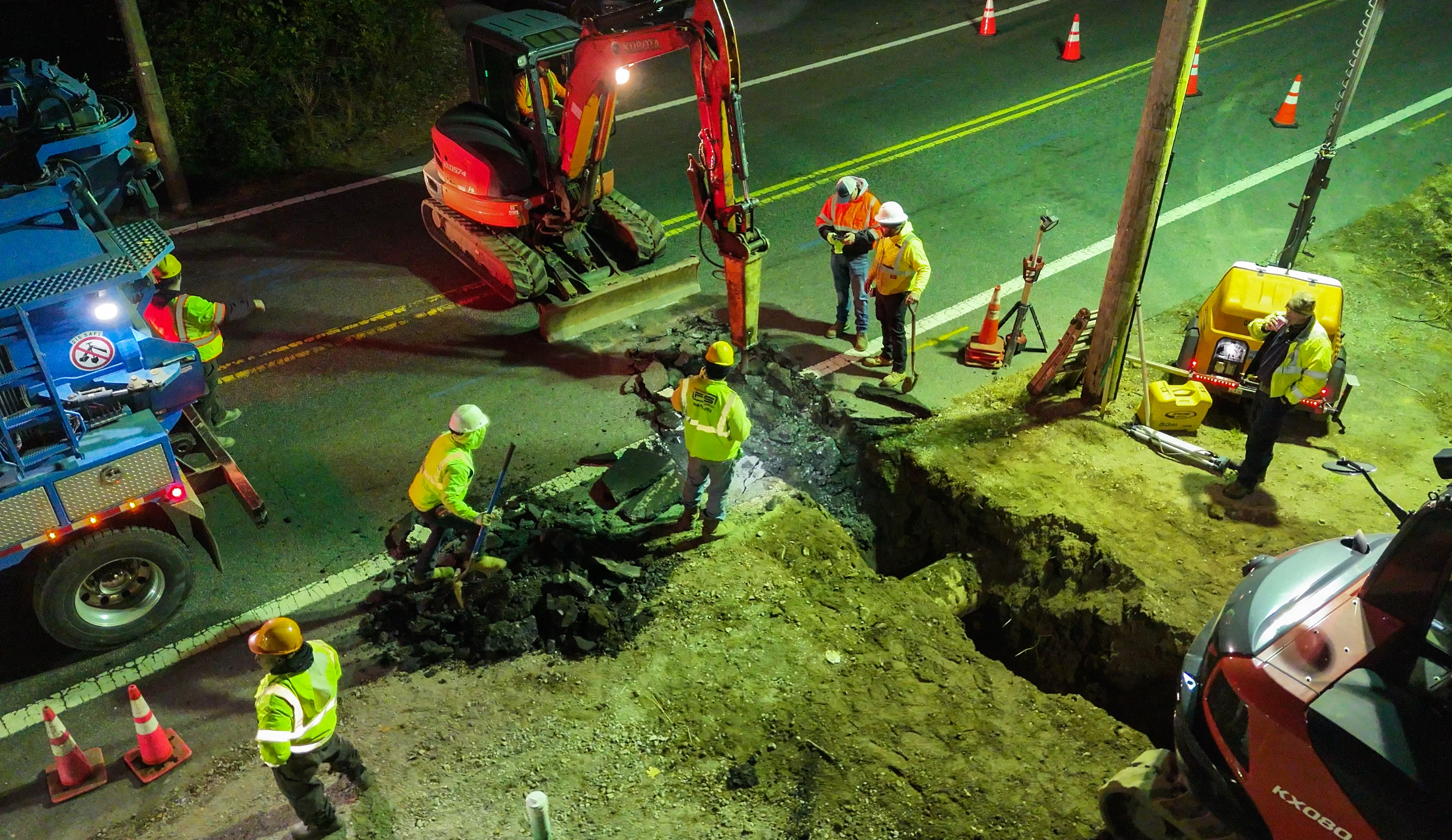 Crew working road excavation at night