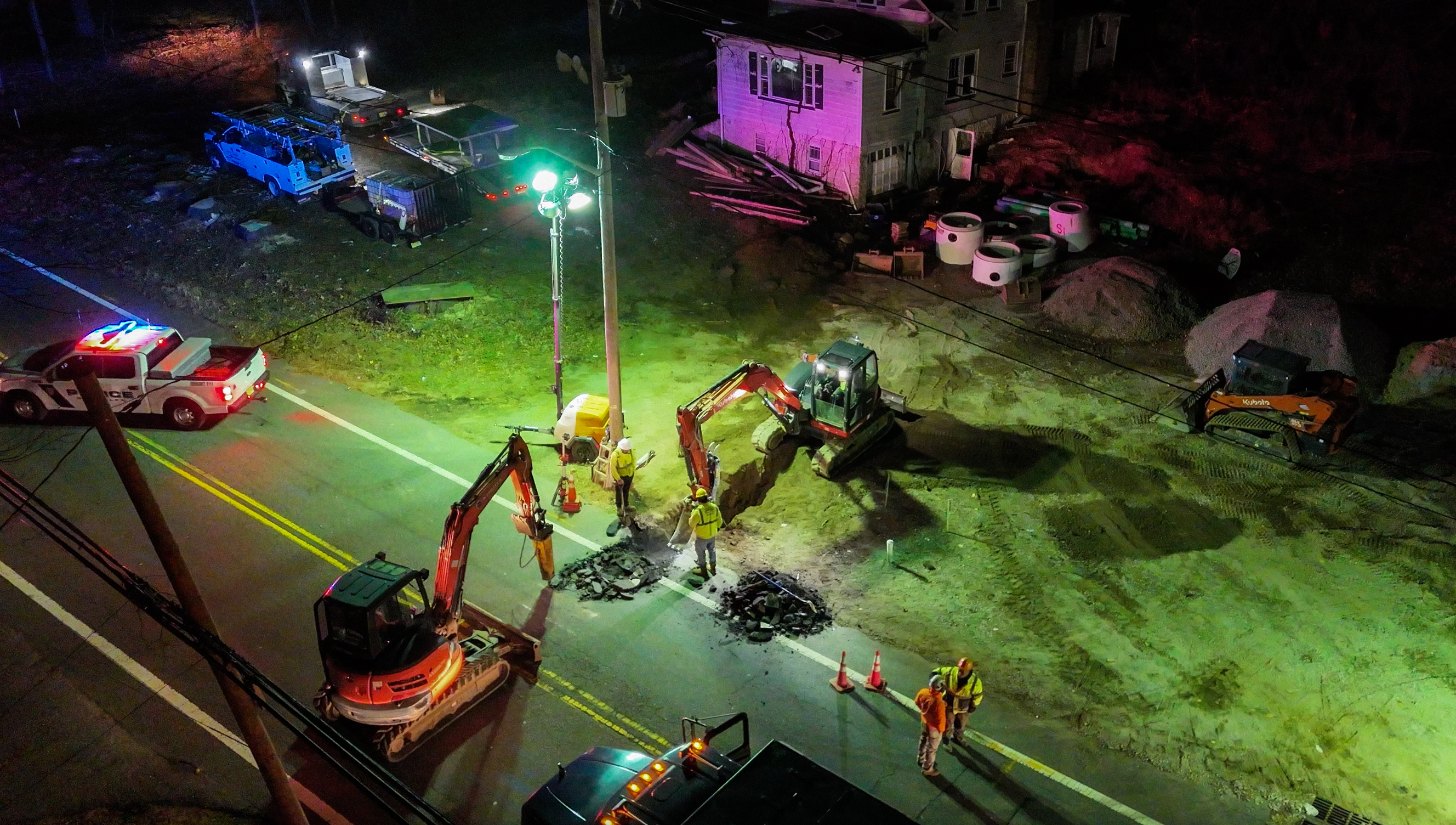 Aerial night view of multi-equipment excavation