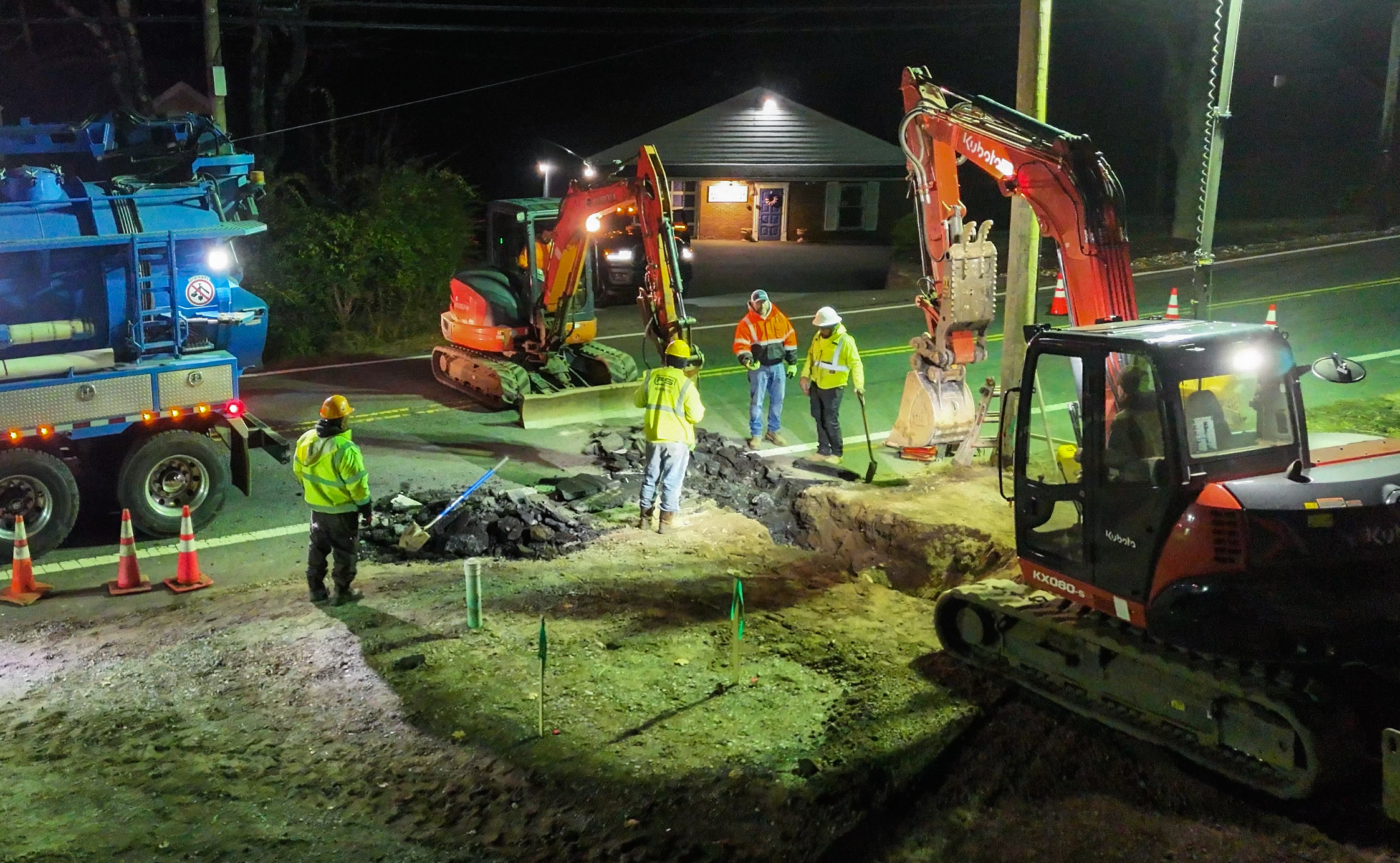 Night excavation crew with safety lighting