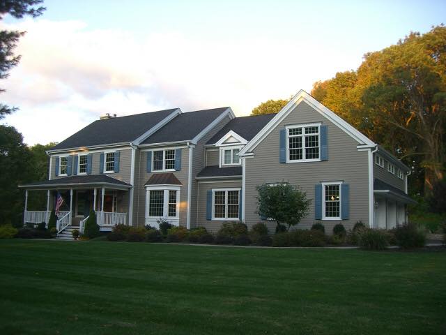 Manicured lawn and foundation plantings on Colonial home