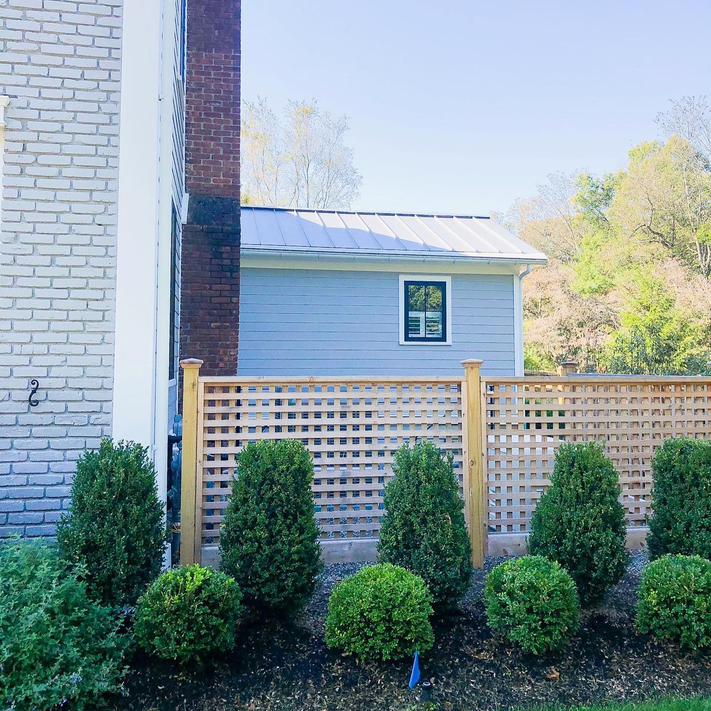 Privacy fence with boxwood hedge installation